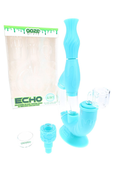 Aqua Teal Ooze Echo silicone/glass 4-in-1 water pipe kit with bowl, banger, nail, and dish shown next to retail box, angled view for head-shop buyers. Aqua Teal Ooze Echo silicone/glass 4-in-1 water pipe kit with bowl, banger, nail, and dish shown next to retail box, angled view for head-shop buyers.