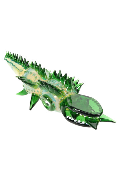 Green silver-fumed glass gator hand pipe, angled side view showing back bowl and side carb; large 18" novelty for smoke-shop displays. Green silver-fumed glass gator hand pipe, angled side view showing back bowl and side carb; large 18" novelty for smoke-shop displays.