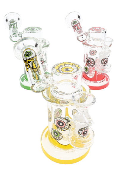 5.5" sidecar glass-on-glass water pipe with eyeball decal, showerhead perc and 14.5 mm joint, multicolor accents, three-quarter studio angle for wholesale listings. 5.5" sidecar glass-on-glass water pipe with eyeball decal, showerhead perc and 14.5 mm joint, multicolor accents, three-quarter studio angle for wholesale listings.