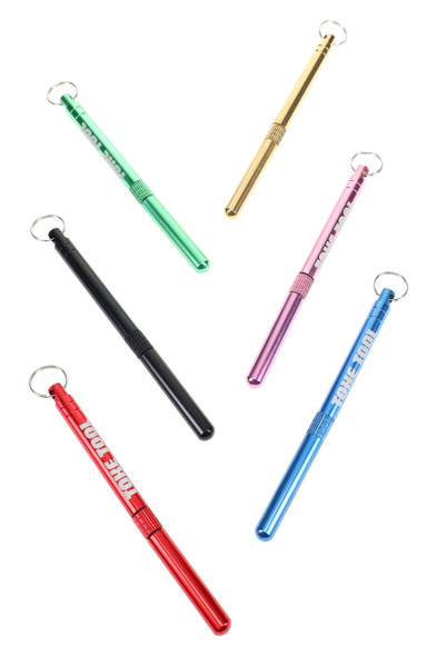 Wholesale 3.5″ metal Stoned Earth Toke Tools in assorted red/blue/black/green/brass/pink colors, keychain multi-tool flat lay on clean white.