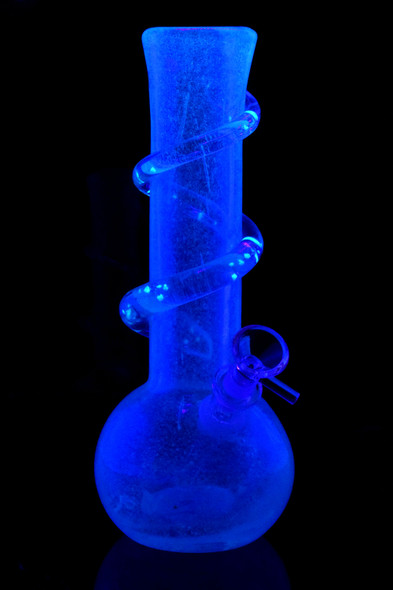Glow-in-the-dark 10" soft-glass round base GoG water pipe with spiral wrap, shown under black light; great head-shop display piece for holiday promos.