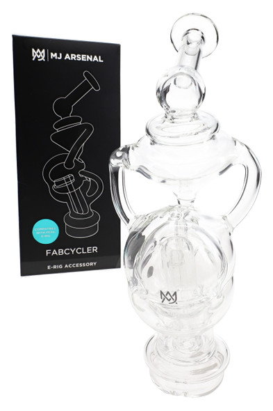 MJ Arsenal Fabcycler glass top beside black retail box, clear recycler body with fab egg diffusion; shelf-ready head-shop accessory shown close view.