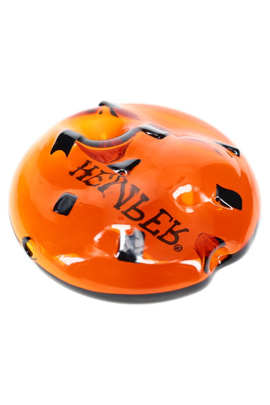 Amber cookie-shaped glass hand pipe with dark “chip” accents and bowl detail, angled—retail smoke gear