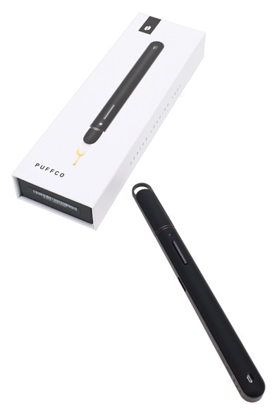 Boxed Puffco heated loading tool for vape accessory resale, black unit with retail packaging at angled view