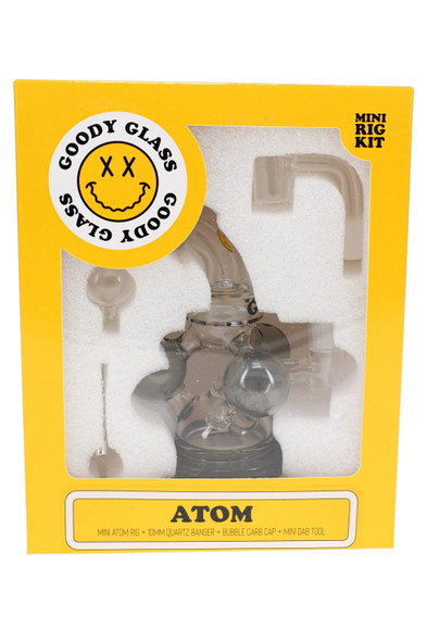 Goody Glass Atom Mini Rig Kit in yellow retail box with smoke-colored rig, quartz banger, carb cap, and dab tool visible through window
