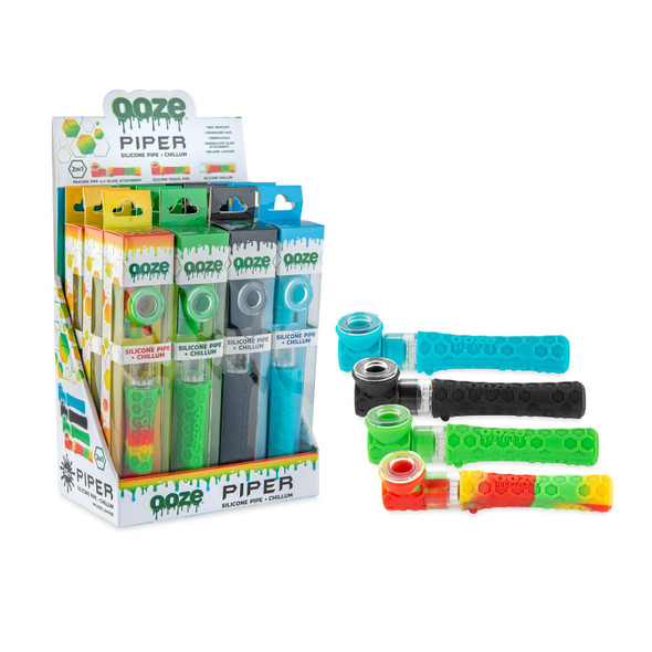 Ooze Piper countertop display featuring assorted silicone pipe and chillum units in teal, black, green, and Rasta colorways