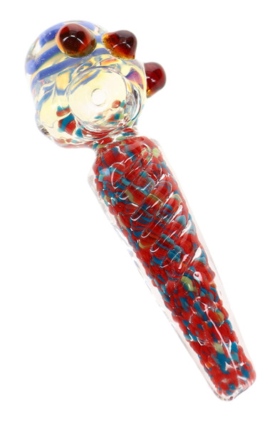 Close-up of a 4.5" color-changing glass spoon pipe featuring a blue striped bowl, red and blue confetti frit handle, clear spiral wrap, and decorative glass marbles.