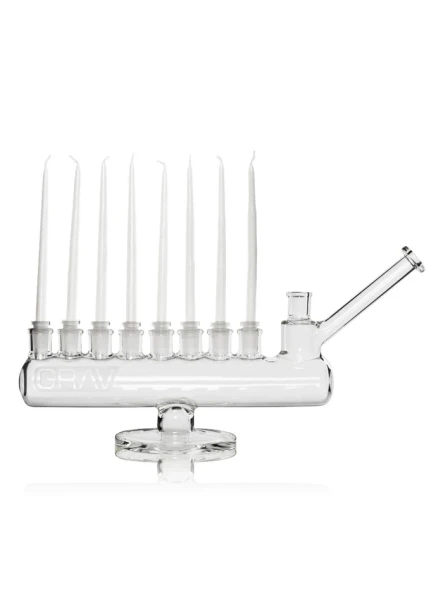 Clear GRAV Menorah water pipe shown with eight white taper candles seated in glass candleholders