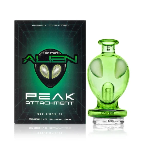 Hemper Alien Puffco Peak glass top displayed beside its branded retail box on white
