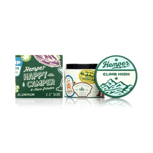Hemper Happy Camper 4-part grinder displayed beside its camping-themed branded retail box