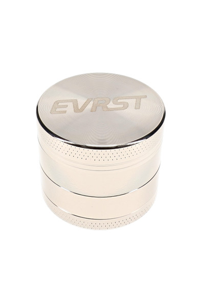 Silver EVRST 4-part metal grinder assembled with engraved logo lid and textured grip bands around the edges