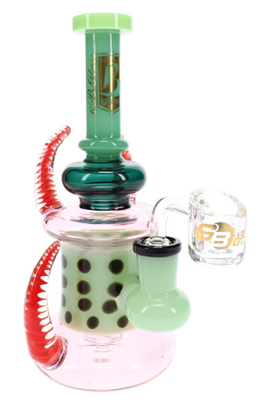 6B Glass dab rig with green neck, dotted inner section, pink body, red spiral-patterned spikes, and clear banger.