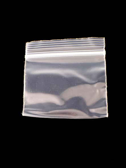 Wholesale 2-inch × 2-inch clear plastic mini zipper baggie, single pouch on black backdrop, showing sturdy resealable seal and square profile for retail buyers.