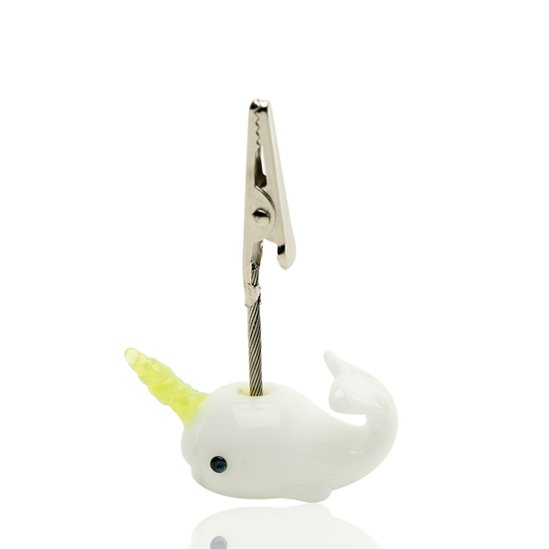 Side view of Cozmic Narwhal alligator clip, white borosilicate body and green horn with stainless clip—head-shop wholesale counter add-on.