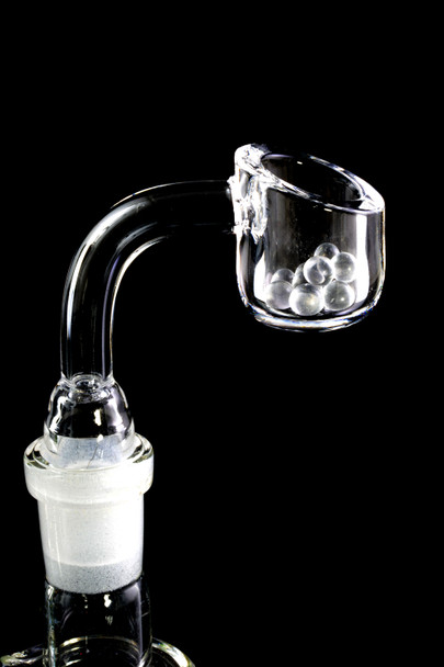 Flat-top quartz banger on a rig holding several 4 mm clear beads; side profile detail for wholesale dabbing accessories.