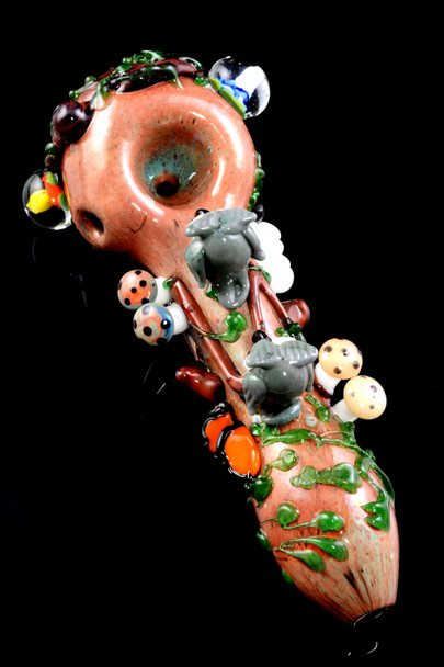 Top-down forest-theme glass spoon for head-shop buyers, 4.5" borosilicate in log brown with vines, owls, ladybug, and mushrooms, glossy black angle.