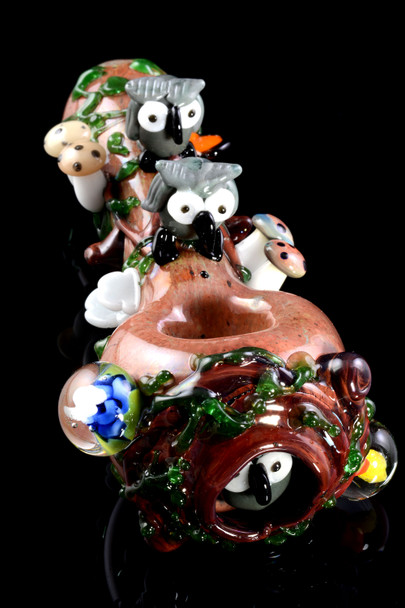 Front bowl view for retail smoke gear—woodland spoon pipe with two gray owls, vine work, and floral marbles, studio black background for showcase.
