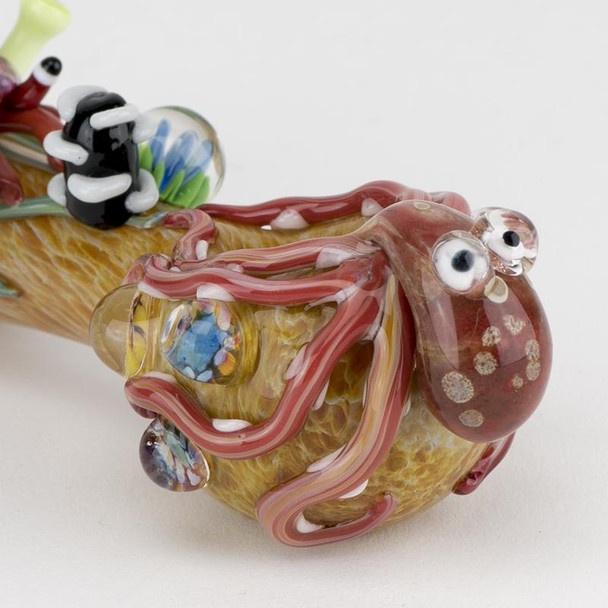 Left-side studio view for head-shop supplies, 4.5" borosilicate kraken spoon in tan with multicolor reef marbles, light gray backdrop.