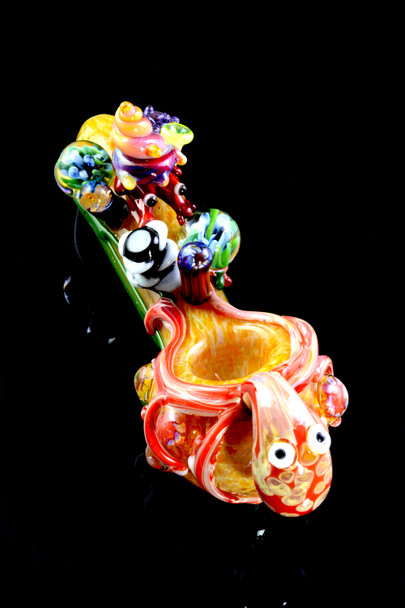 Wholesale ocean-theme spoon pipe, 4.5" borosilicate with coral accents and octopus wrap, bowl-forward three-quarter angle on glossy black.