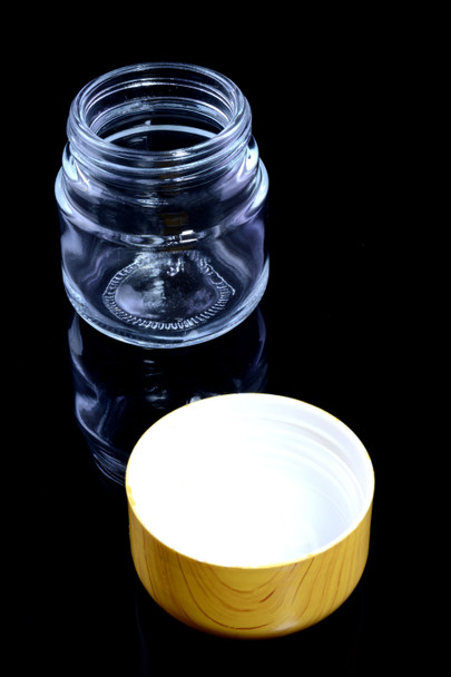 wholesale glass jar and lid separated, overhead angle showing tamper-evident insert and wide-mouth opening for easy filling
