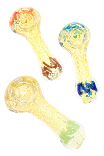 Assorted small fumed color-changing glass spoon pipes with translucent golden finish, textured frit interior, rounded bowls, and colorful worked glass accents.