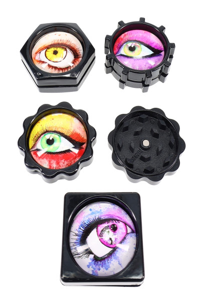 Assorted 1.25-in plastic eyeball mini grinders, 2-part with magnet; components laid out on white; wholesale catalog photo.