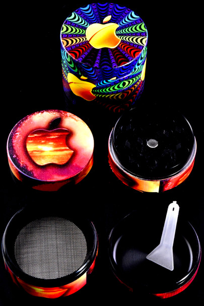 Psychedelic apple variant zinc-alloy 4-part grinder on black backdrop, screen and scraper visible; wholesale accessory photo.