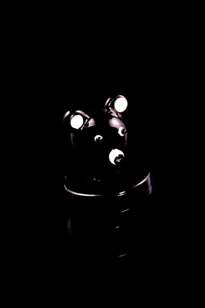 Black glass koala bear carb cap with white ear accents; head-shop dabbing accessory, centered low-light shot on deep black background.