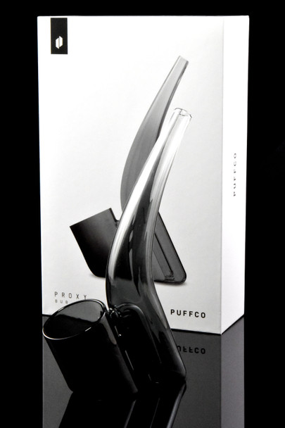 Smoke-black Proxy Bub posed before retail box, front studio view—shelf-ready Puffco attachment for retail smoke-shop displays.