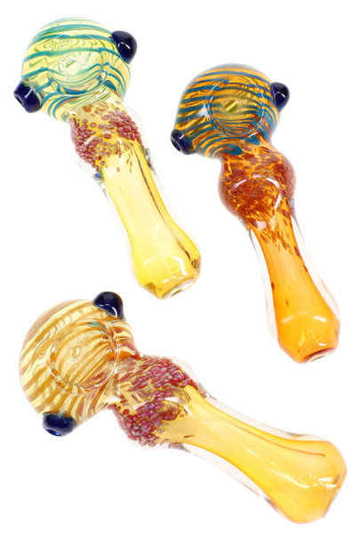Top-down trio of 4" silver-fumed, frit-striped spoon pipes in assorted hues; color-changing glass with side marbles for wholesale head-shop buyers.