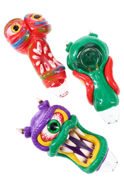 Trio of 4.5" monster glass spoons in red, green, and purple with raised teeth and eyes, clear tips; compact novelty pipe for wholesale head-shop displays.