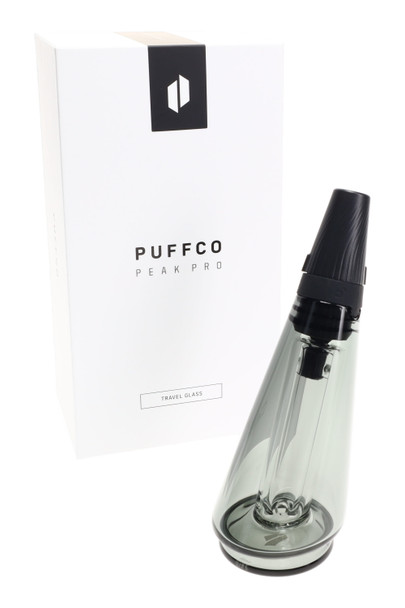 Smoke-gray tinted Puffco Travel Glass with black twist cap beside retail box—premium head-shop attachment ready for wholesale shelves.
