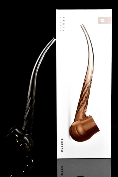 Desert Wizard glass beside retail box, studio lighting—shelf-ready Puffco Proxy attachment for smoke-shop displays.