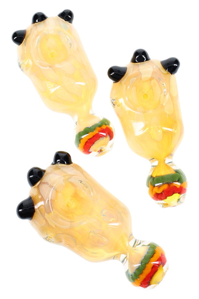 Three 4" silver-fumed color-changing glass spoons with black marble accents and rasta swirl mouthpieces; wholesale head-shop photo, angled top view.