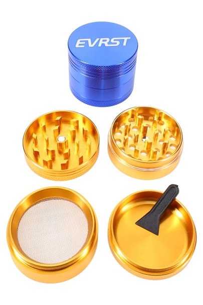 EVRST logo grinder in gold/green, 4 pieces shown with mesh screen and scraper on white backdrop; aluminum build for wholesale buyers.