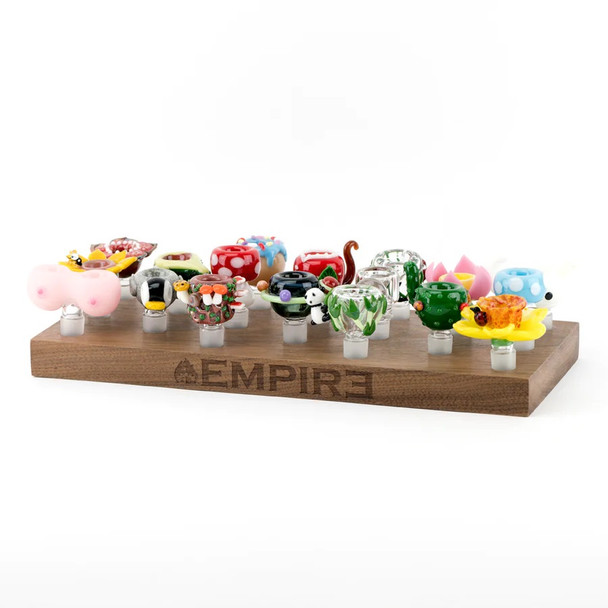 Display loaded with assorted 14.5 mm novelty bowls on clear ground joints; Empire-branded wood stand for retail smoke gear merchandising, front angle.