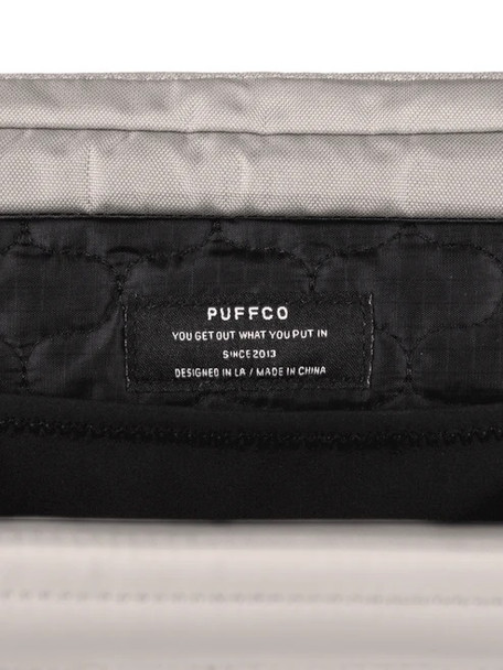 Interior label close-up inside Proxy Travel Bag, quilted lining detail and stitching; wholesale accessory compliance view.