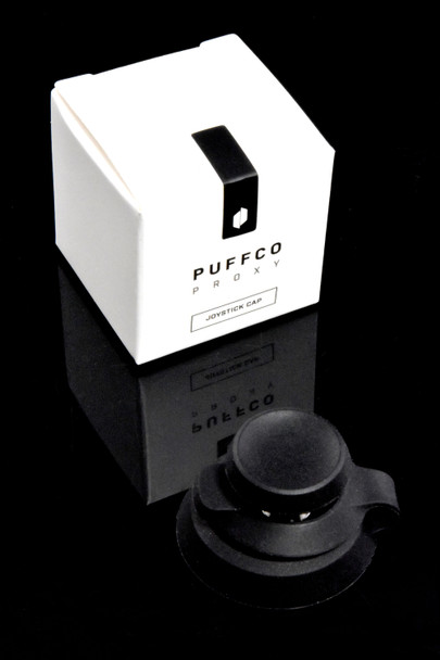 Black Joystick Cap with branded retail box on black reflective surface; compact accessory packaging for head-shop supply orders.