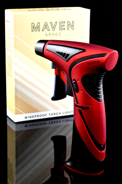 Wholesale red Maven Space torch lighter with single jet flame, ergonomic grip; left-angle shot beside beige retail box.