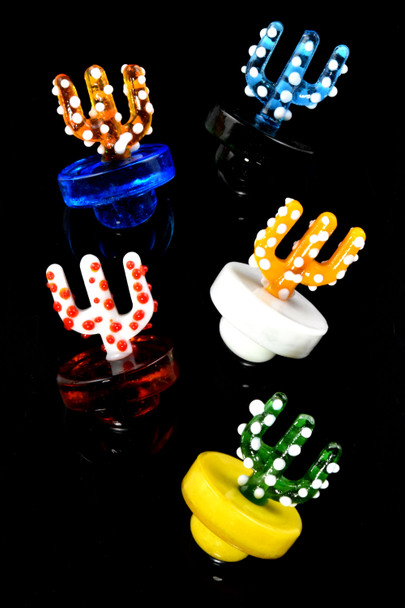 Six assorted glass cactus carb caps on black background; 1.5-inch head-shop supply, colored glass with white dots, angled group shot.