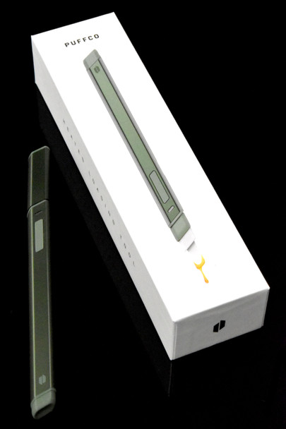 Flourish green Hot Knife beside Puffco retail box on black; limited colorway with USB-C loading tool shown for B2B head-shop accessory listings.