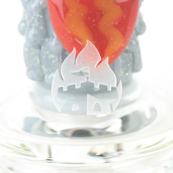 Alternate close view emphasizing circular windows and red nose cone inside clear glass; head-shop display accessory photographed at angle.