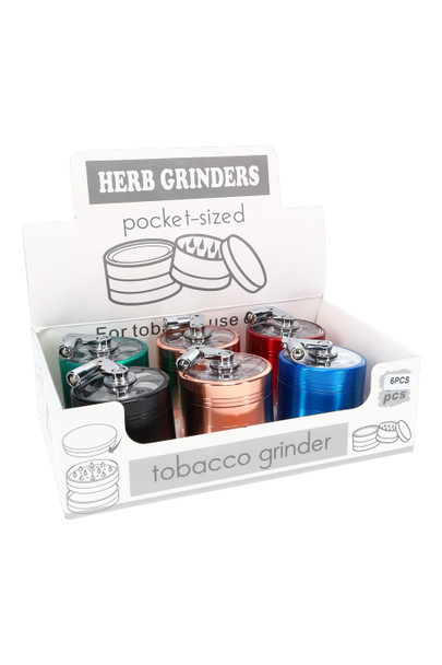 Counter display with six zinc alloy hand crank grinders and clear lids, angled studio shot for wholesale smoke shop use.