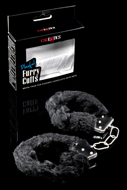 Black faux fur metal handcuffs with keys beside empty retail box, right-angle closeup—wholesale add-on for adult shops.