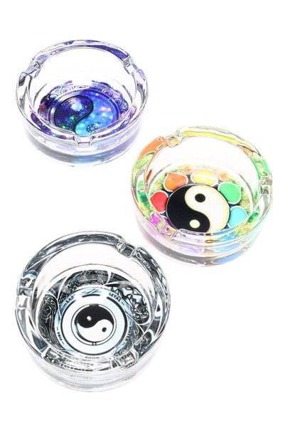 Bulk preview of three 3.25-inch glass ashtrays with colorful yin-yang decals, top-down on white background