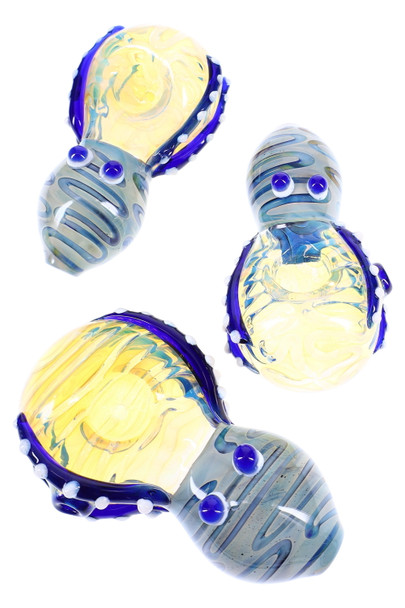 Silver-fumed 4" octopus glass spoon with blue tentacle accents and glass eyes, color-changing bowl; three angles for wholesale head-shop product detail. Silver-fumed 4" octopus glass spoon with blue tentacle accents and glass eyes, color-changing bowl; three angles for wholesale head-shop product detail.