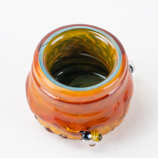 Top-down detail of Honeycomb Terp Jar opening showing green interior swirl and bee accent—borosilicate concentrate jar for head-shops.