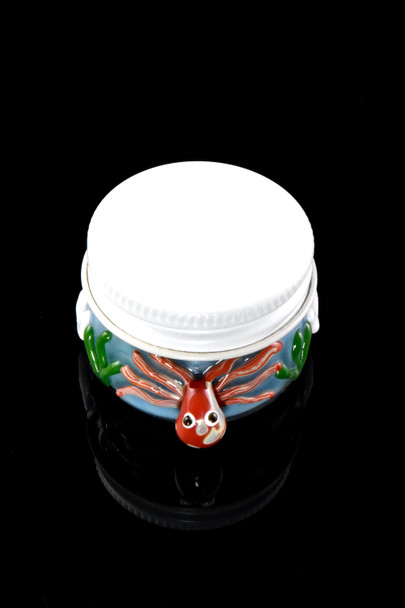 Bulk retail smoke gear Under the Sea terp jar front on black, white lid closed, red octopus and green kelp accents.