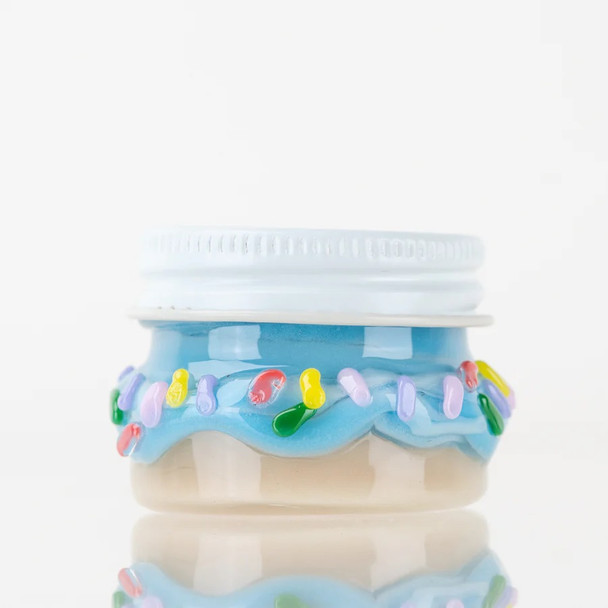 Bulk head-shop supplies donut terp jar, 1.5 inch borosilicate glass, blue frosting and multicolor sprinkles, side profile on white studio background.