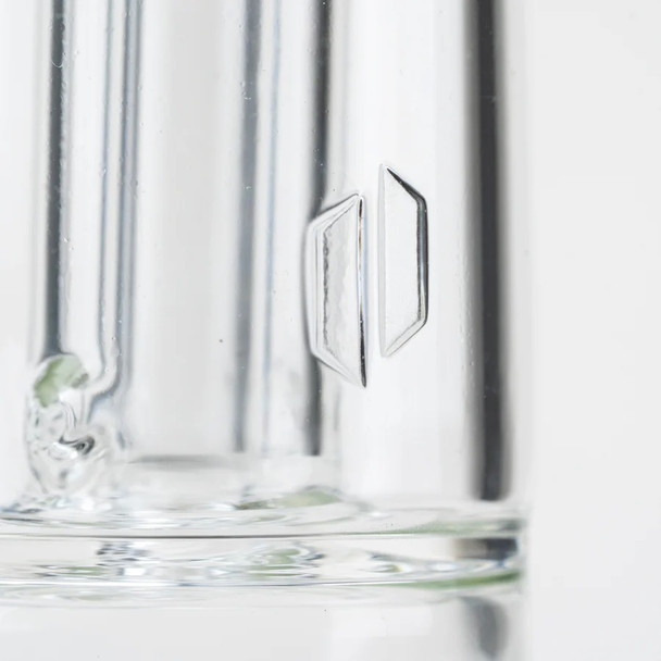 Close macro of clear borosilicate chamber with geometric accent; premium tall attachment for wholesale head-shop displays, polished glass detail.